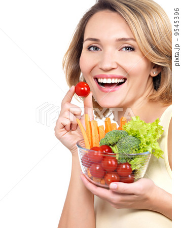 Beautiful young healthy woman with a plate of vegetables. 9545396