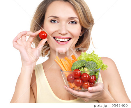 Beautiful young healthy woman with a plate of vegetables. Beautiful young healthy woman with a plate of vegetables. 9545400