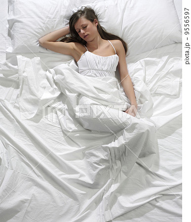 Young blonde woman sleeping in the bed 9556597