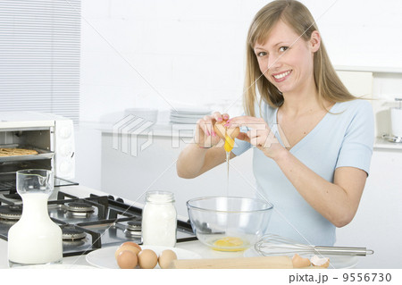 .Beautiful woman in kitchen is making a cake 9556730