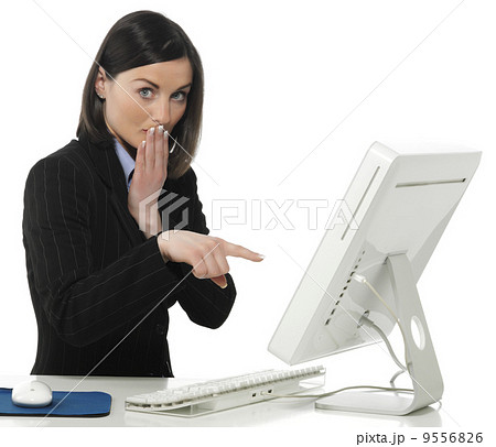 Beautiful businesswoman in her office indicating something on laptop 9556826