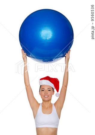 Asian girl with a ball in his raised hands 9560536