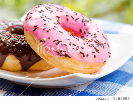 Fresh donuts on nature background 9569697