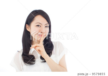 唇に指を当てる女性の写真素材