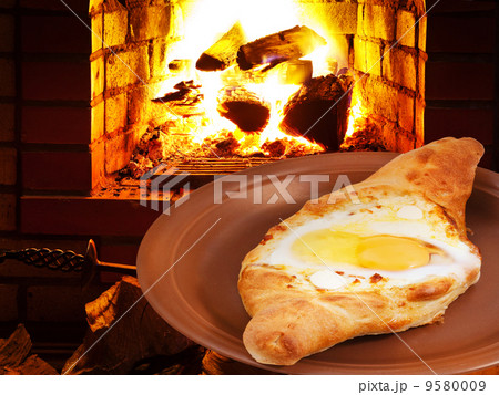 hachapuri with egg on plate and fire in stove 9580009