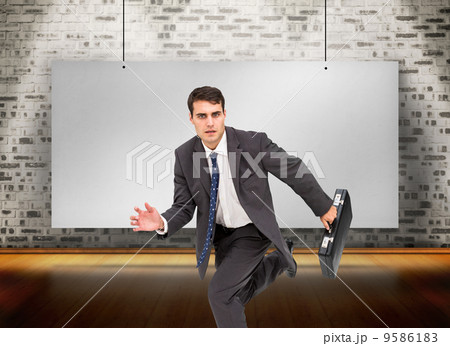 Composite image of stern businessman in a hury 9586183