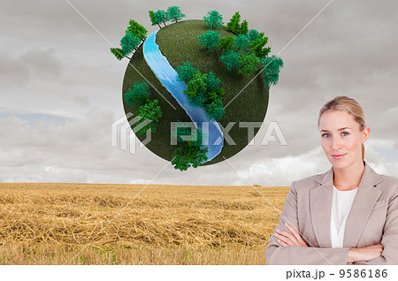 Composite image of confident female executive with folded arms Composite image of confident female executive with folded arms 9586186