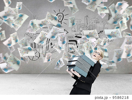 Composite image of businesswoman carrying folders 9586218