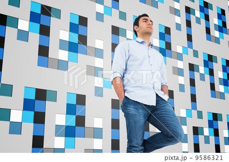 Composite image of unsmiling casual man standing Composite image of unsmiling casual man standing 9586321