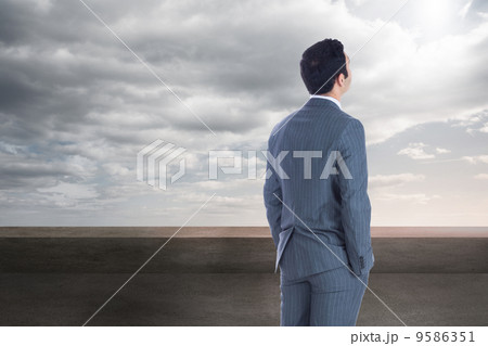 Composite image of businessman standing 9586351