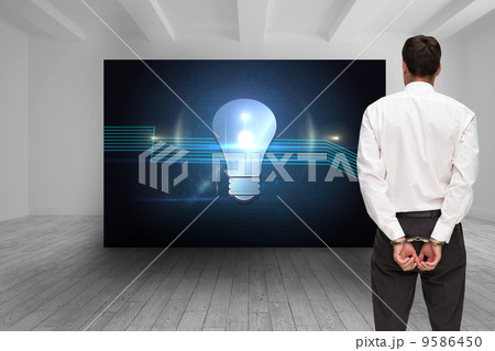 Composite image of rear view of young businessman wearing handcu 9586450