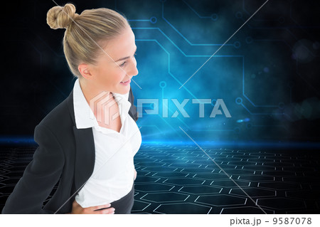 Composite image of businesswoman standing with hands on hips 9587078