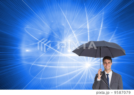 Composite image of happy businessman holding grey umbrella Composite image of happy businessman holding grey umbrella 9587079