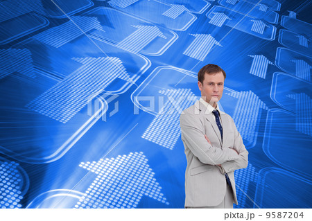 Composite image of serious businessman standing with his arms fo Composite image of serious businessman standing with his arms fo 9587204