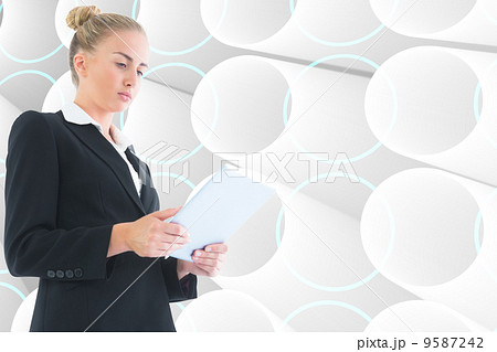 Composite image of businesswoman holding tablet Composite image of businesswoman holding tablet 9587242