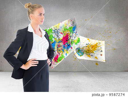 Composite image of businesswoman standing with hands on hips 9587274