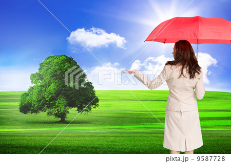 Composite image of businesswoman holding umbrella Composite image of businesswoman holding umbrella 9587728