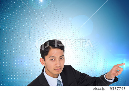 Composite image of unsmiling asian businessman pointing 9587743