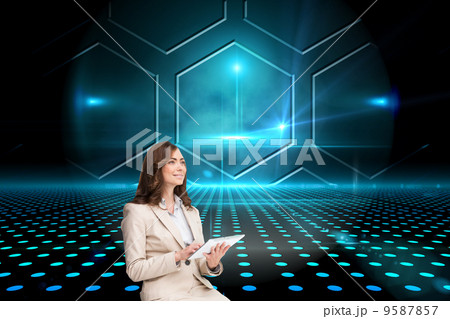Composite image of businesswoman holding tablet and looking up Composite image of businesswoman holding tablet and looking up 9587857