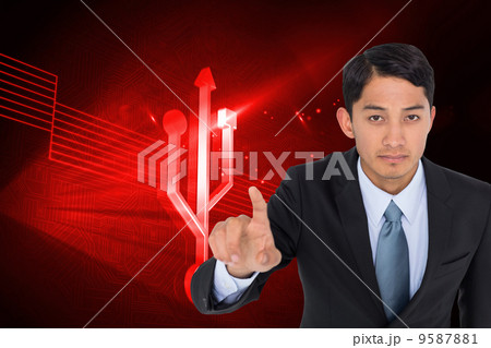 Composite image of serious asian businessman pointing Composite image of serious asian businessman pointing 9587881