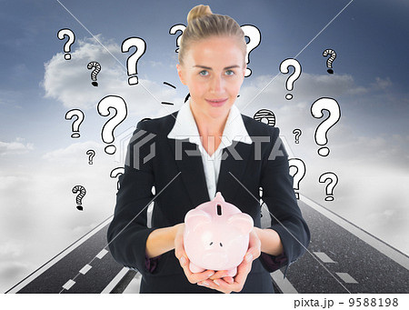 Composite image of businesswoman holding piggy bank Composite image of businesswoman holding piggy bank 9588198