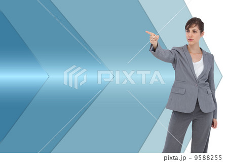 Composite image of young businesswoman pointing to something 9588255