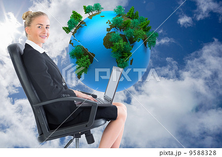 Composite image of businesswoman sitting on swivel chair with la 9588328