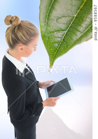 Composite image of businesswoman holding tablet Composite image of businesswoman holding tablet 9588567