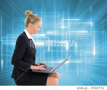 Composite image of businesswoman using laptop 9588732