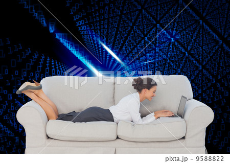 Composite image of business woman lying on couch Composite image of business woman lying on couch 9588822