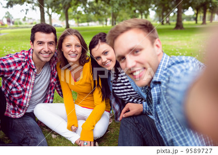 Cheerful young college students in park Cheerful young college students in park 9589727