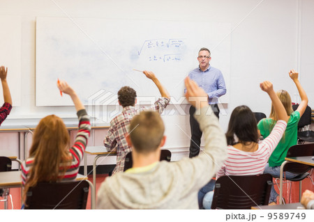 Students raising hands in the classroom Students raising hands in the classroom 9589749