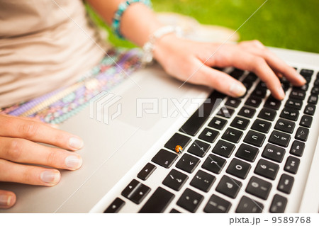 Detail shot of a woman using laptop 9589768
