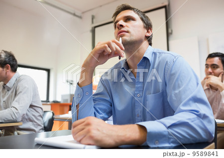 Mature students taking notes in classroom Mature students taking notes in classroom 9589841
