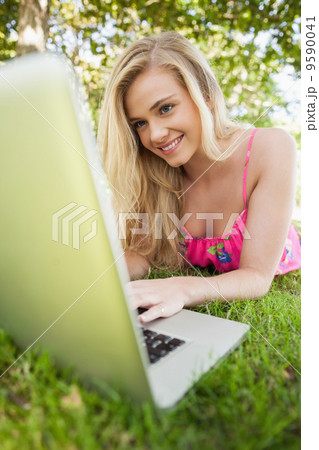 Happy blonde woman using her notebook Happy blonde woman using her notebook 9590041