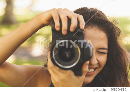Beautiful brunette woman taking a picture Beautiful brunette woman taking a picture 9590432
