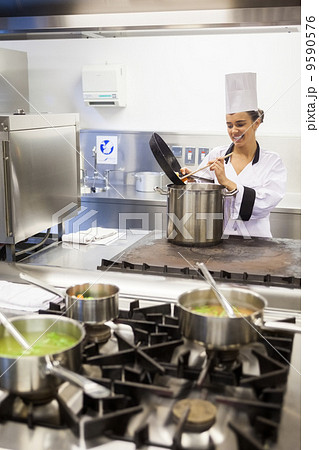 Young cheerful chef preparing meal Young cheerful chef preparing meal 9590576