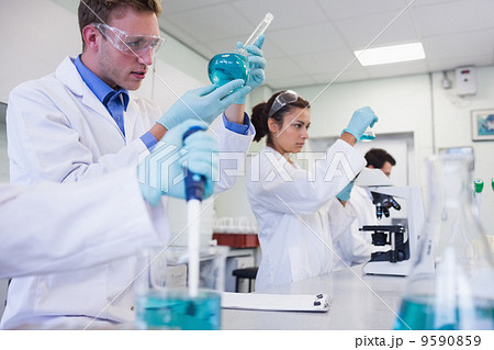 Researchers carrying out experiments in the lab Researchers carrying out experiments in the lab 9590859
