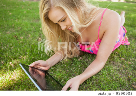 Cheerful young woman using her tablet Cheerful young woman using her tablet 9590903