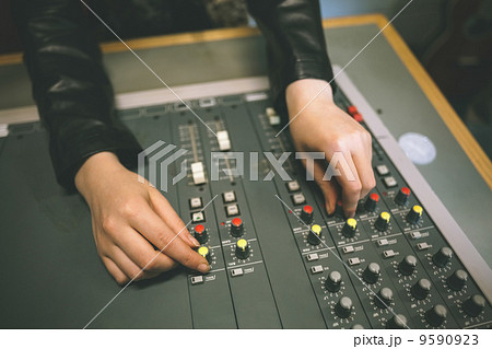 Close up of female hands turning up volume 9590923