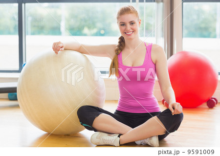 Fit beautiful woman with exercise ball in fitness studio Fit beautiful woman with exercise ball in fitness studio 9591009