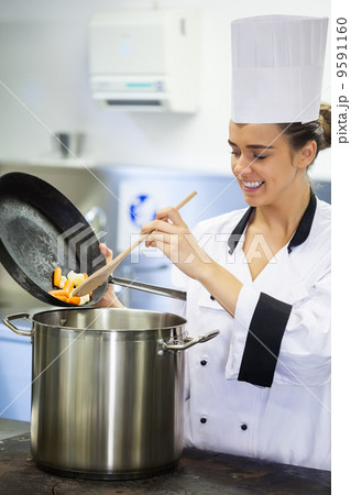 Young smiling chef preparing meal Young smiling chef preparing meal 9591160