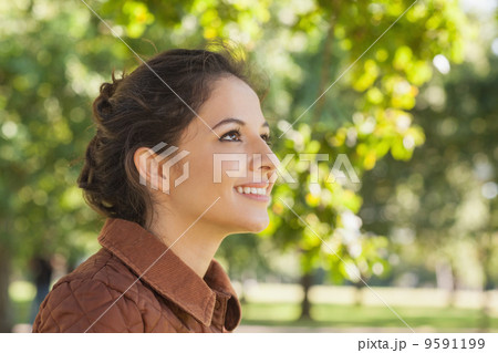 Side view of cute brunette woman wearing a brown coat Side view of cute brunette woman wearing a brown coat 9591199