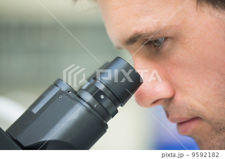 Close-up of a scientific researcher using microscope Close-up of a scientific researcher using microscope 9592182
