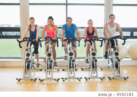 Five determined people working out at spinning class Five determined people working out at spinning class 9592183