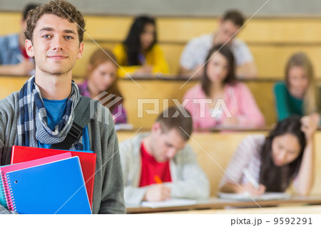 Smiling male with students sitting at lecture hall Smiling male with students sitting at lecture hall 9592291