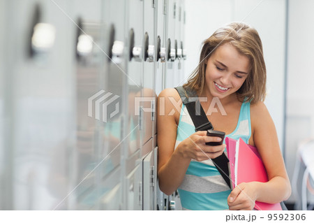 Smiling pretty student texting Smiling pretty student texting 9592306