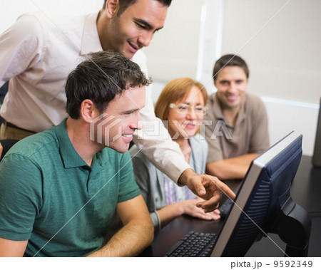 Teacher and mature student in computer room Teacher and mature student in computer room 9592349