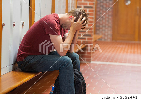 Upset handsome student having a headache 9592441