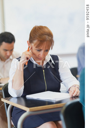 Focused mature student sitting in classroom Focused mature student sitting in classroom 9592458